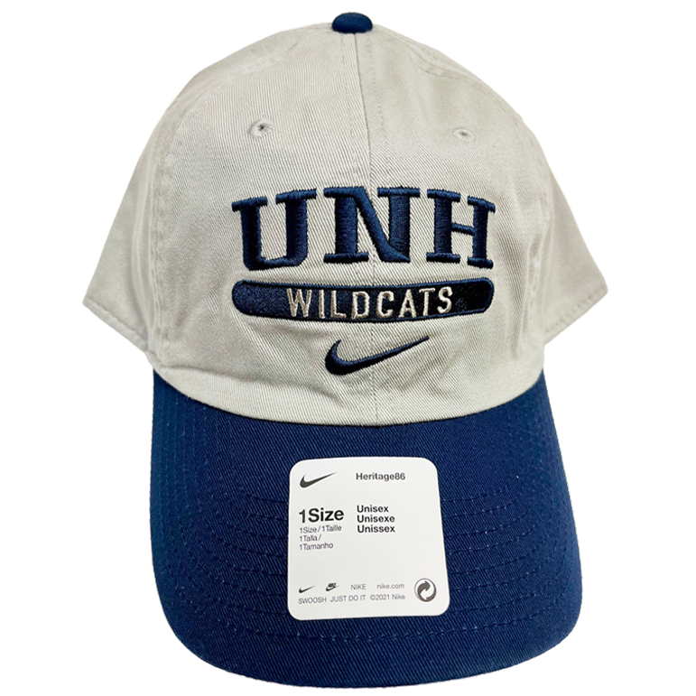 A light grey hat with a navy brim. The hat reads "UNH" in navy stitching, with "Wildcats" underneath in inverse stiching on a navy bar, and a Navy Nike Swoosh stitched below that.